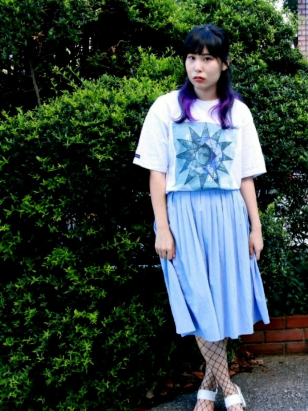 ホワイト系のTシャツ/カットソー、ブルー系のスカート、ホワイト系のサンダルを着用したレディースの秋コーディネートの1枚目の写真