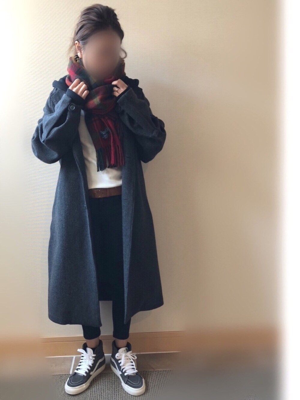 グレー系のチェスターコート、ブラック系のパーカー、ホワイト系のTシャツ/カットソーを着用したレディースの冬コーディネートの1枚目の写真