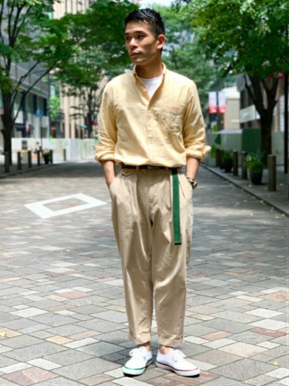 ホワイト系のスニーカー、イエロー系のシャツ/ブラウス、グリーン系のチノパンツを着用したメンズの夏コーディネートの1枚目の写真