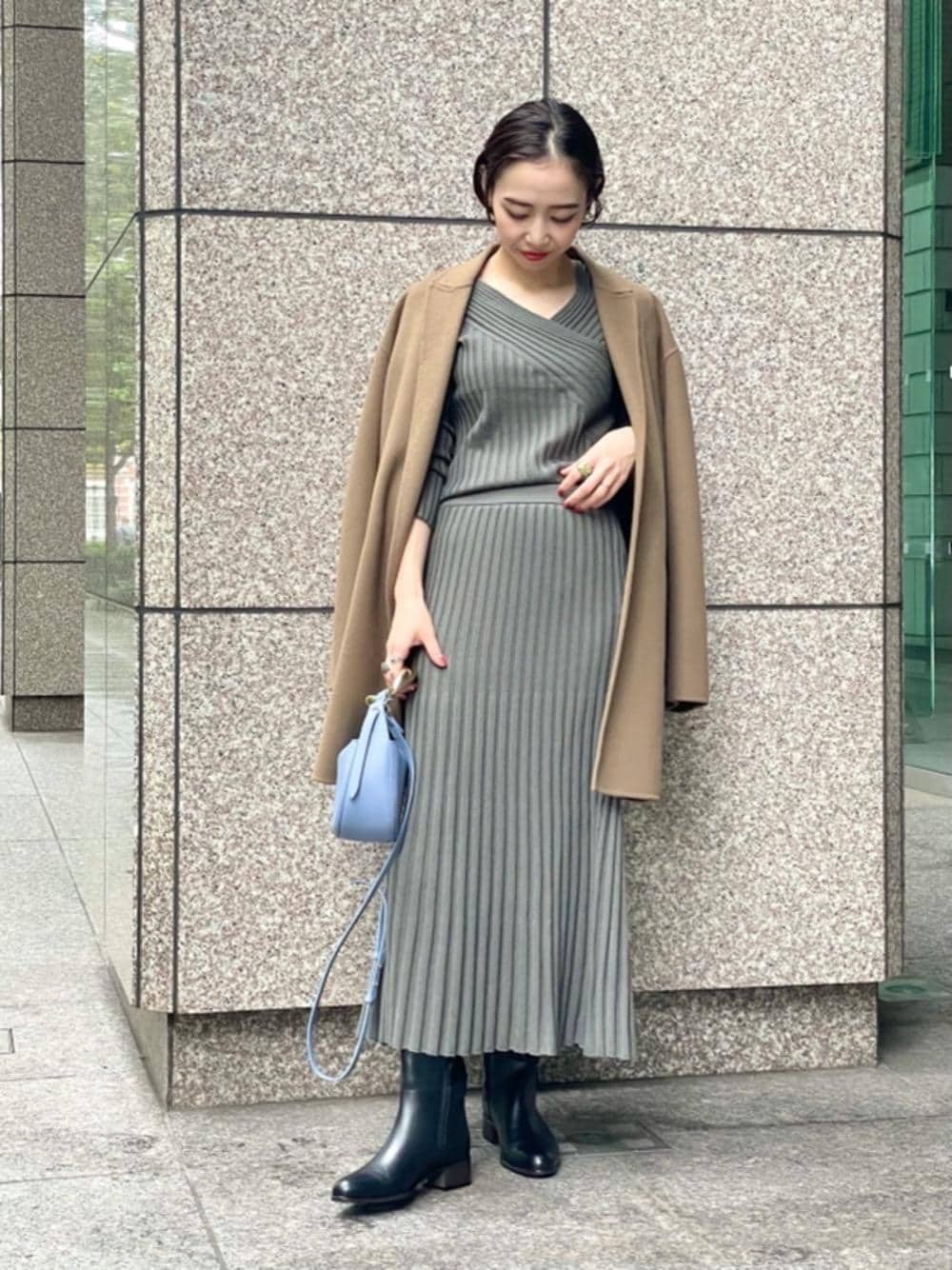 ブラウン系のその他アウター、ブラック系のブーツ、グレー系のスカートを着用したレディースの秋コーディネートの1枚目の写真