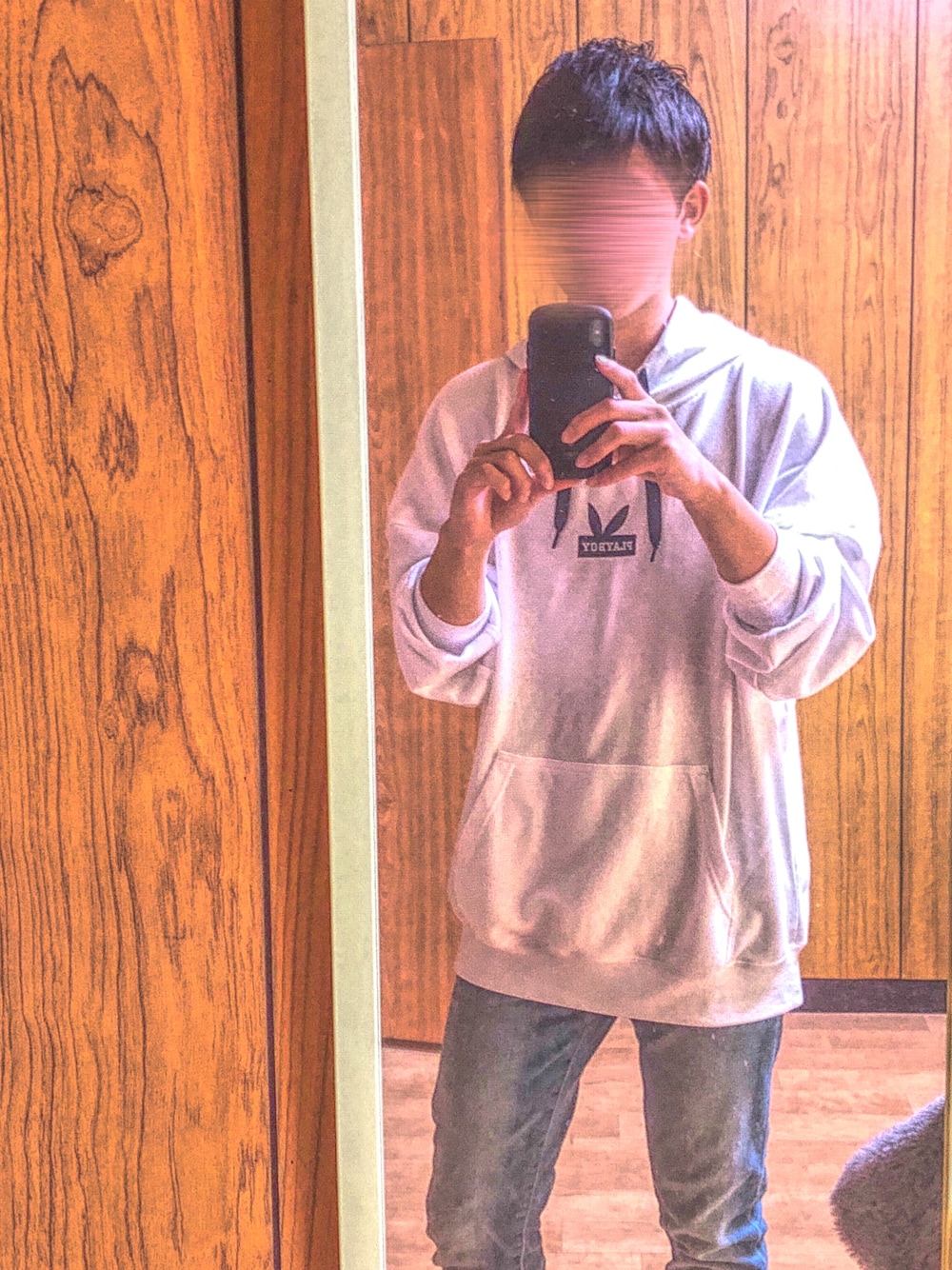 ホワイト系のパーカー、ブルー系のデニムパンツを着用したメンズの秋コーディネートの1枚目の写真