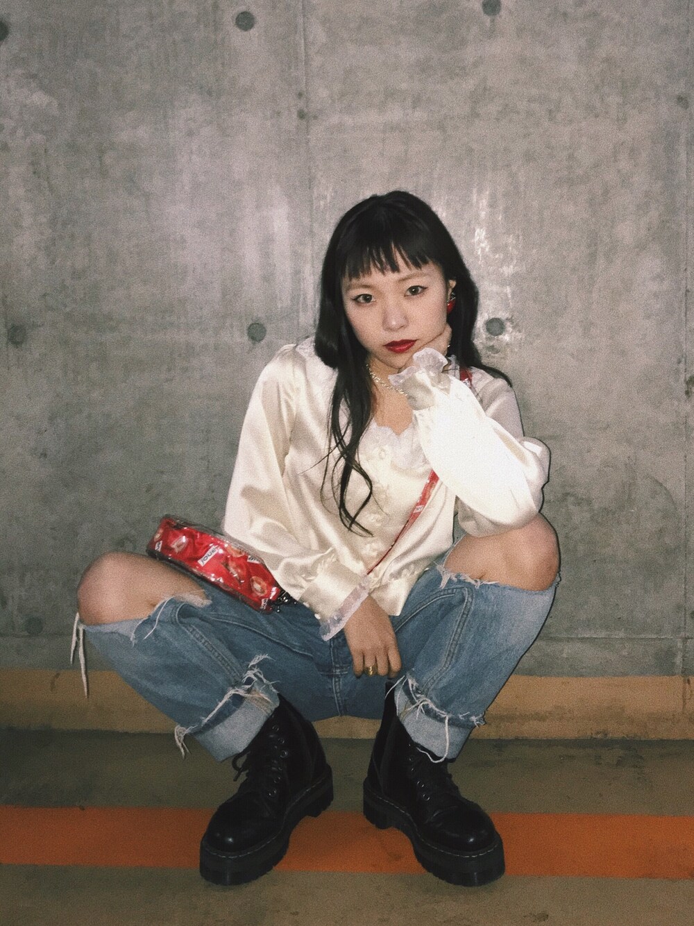 ホワイト系のシャツ/ブラウス、ブラック系のブーツ、レッド系のハンドバッグを着用したレディースの春コーディネートの1枚目の写真