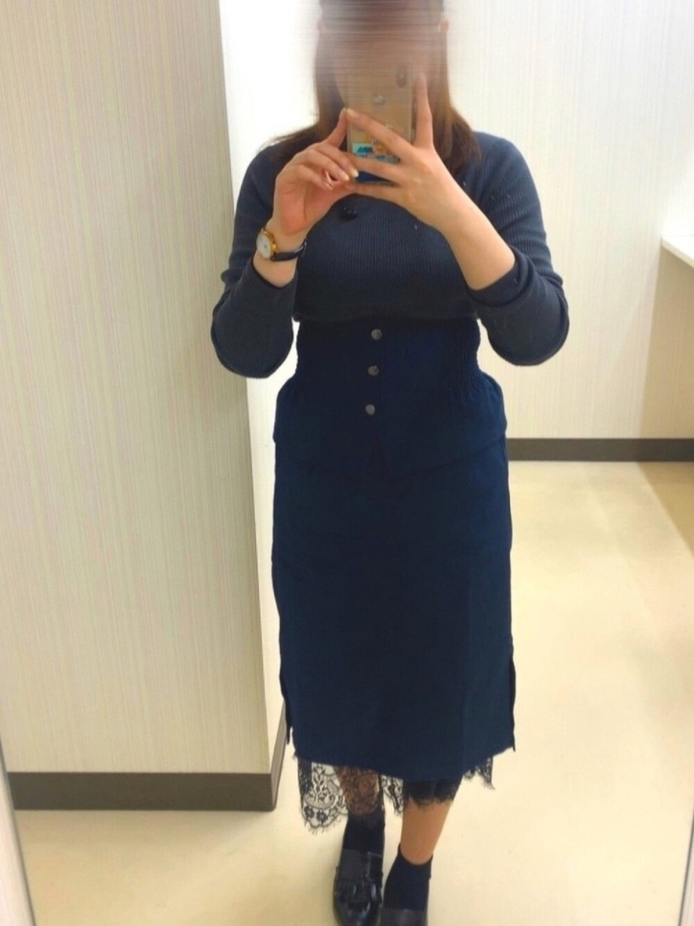グレー系のニット/セーター、ブルー系のスカート、ブラック系のスカートを着用したレディースの冬コーディネートの1枚目の写真