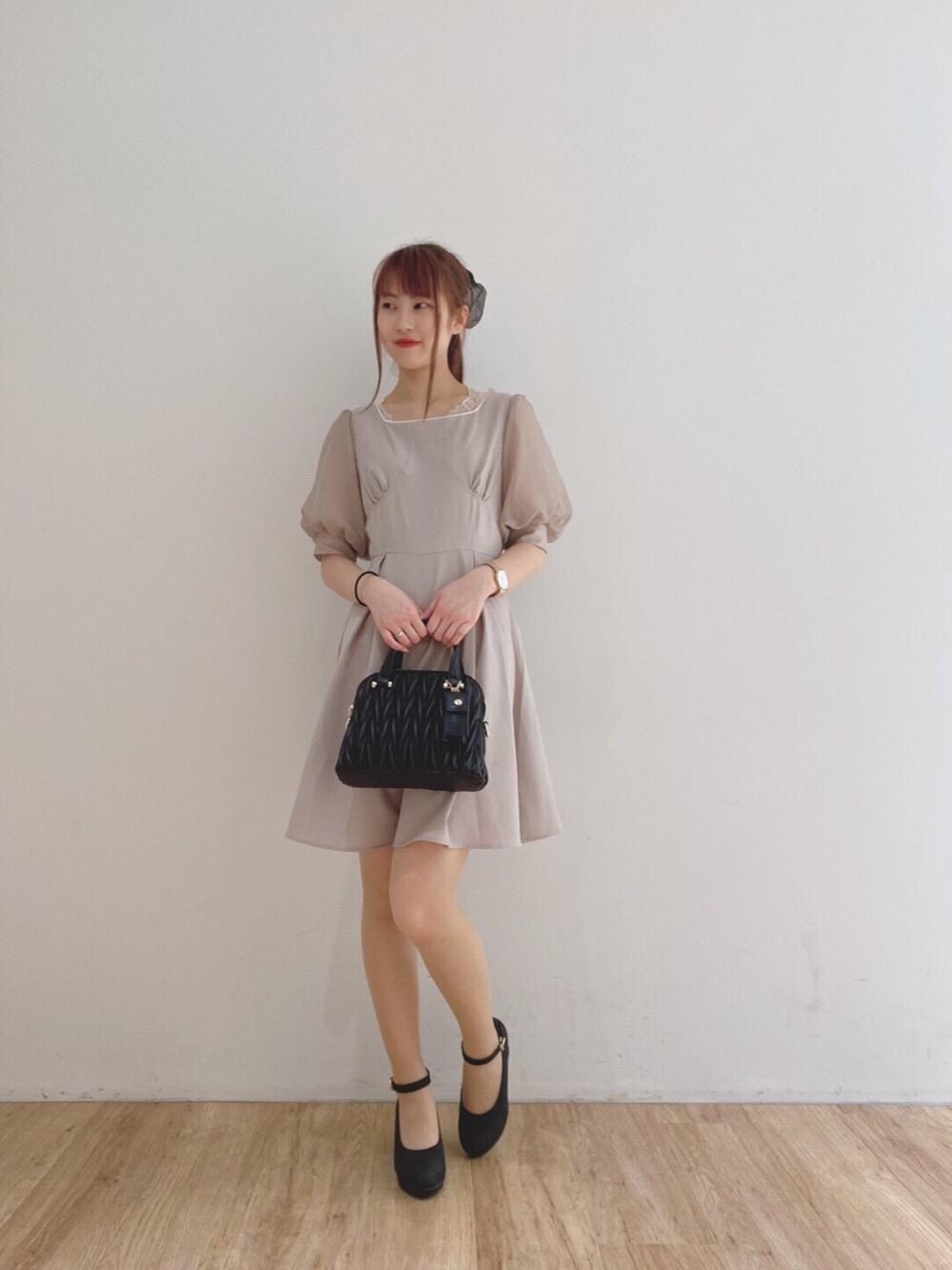 ブラック系のパンプス、ホワイト系のタンクトップ、ブラック系のショルダーバッグを着用したレディースの夏コーディネートの1枚目の写真