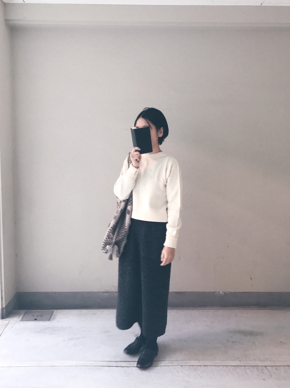 ホワイト系のニット/セーター、グリーン系のスカート、ブラック系のシューズを着用したレディースの冬コーディネートの1枚目の写真