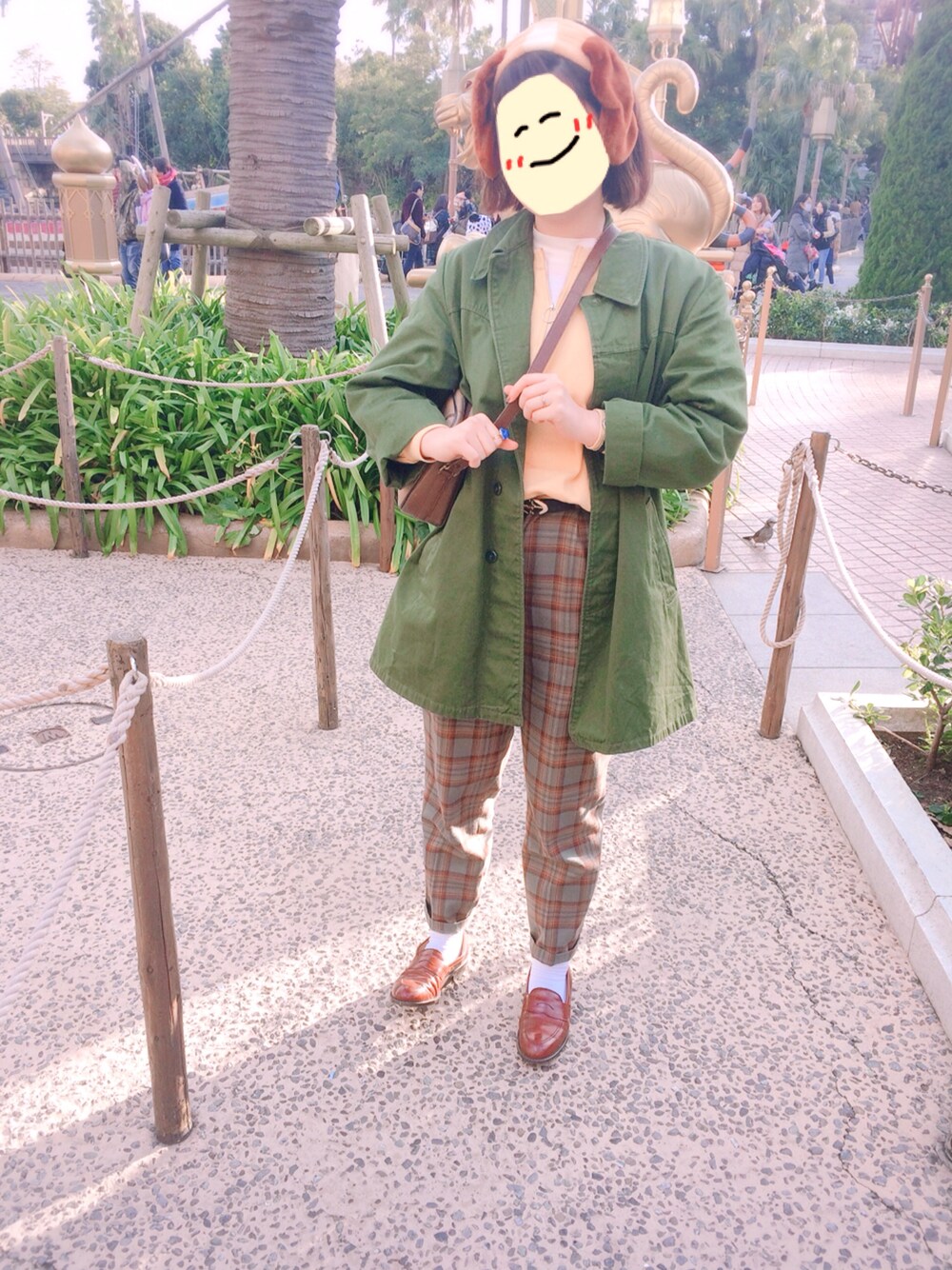 グリーン系のミリタリージャケット、イエロー系のスウェット、ホワイト系のTシャツ/カットソーを着用したレディースの冬コーディネートの1枚目の写真