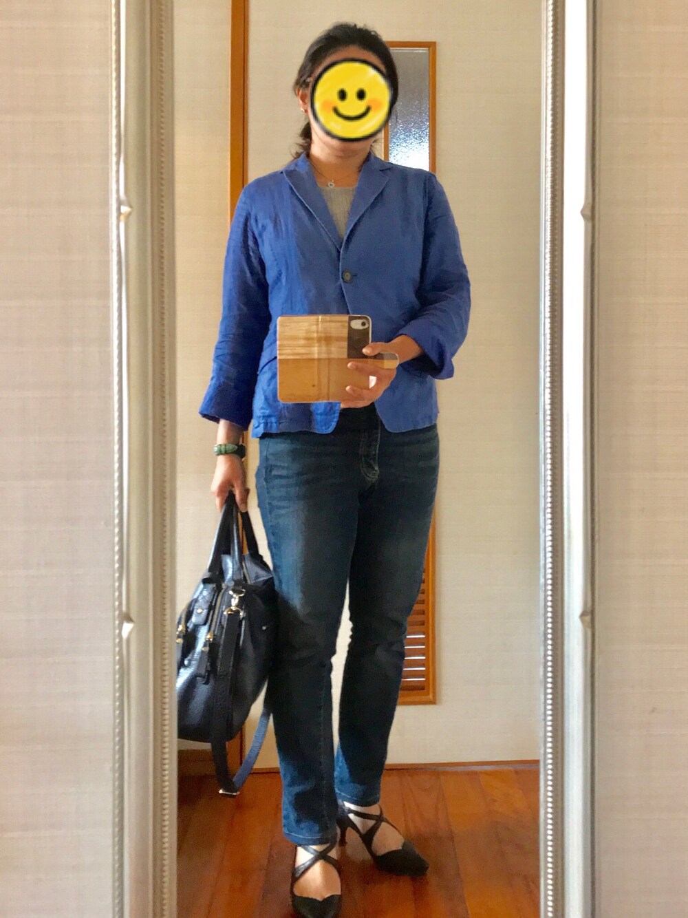 ブラック系のパンプス、グレー系のニット/セーター、ブルー系のハンドバッグを着用したレディースの夏コーディネートの1枚目の写真