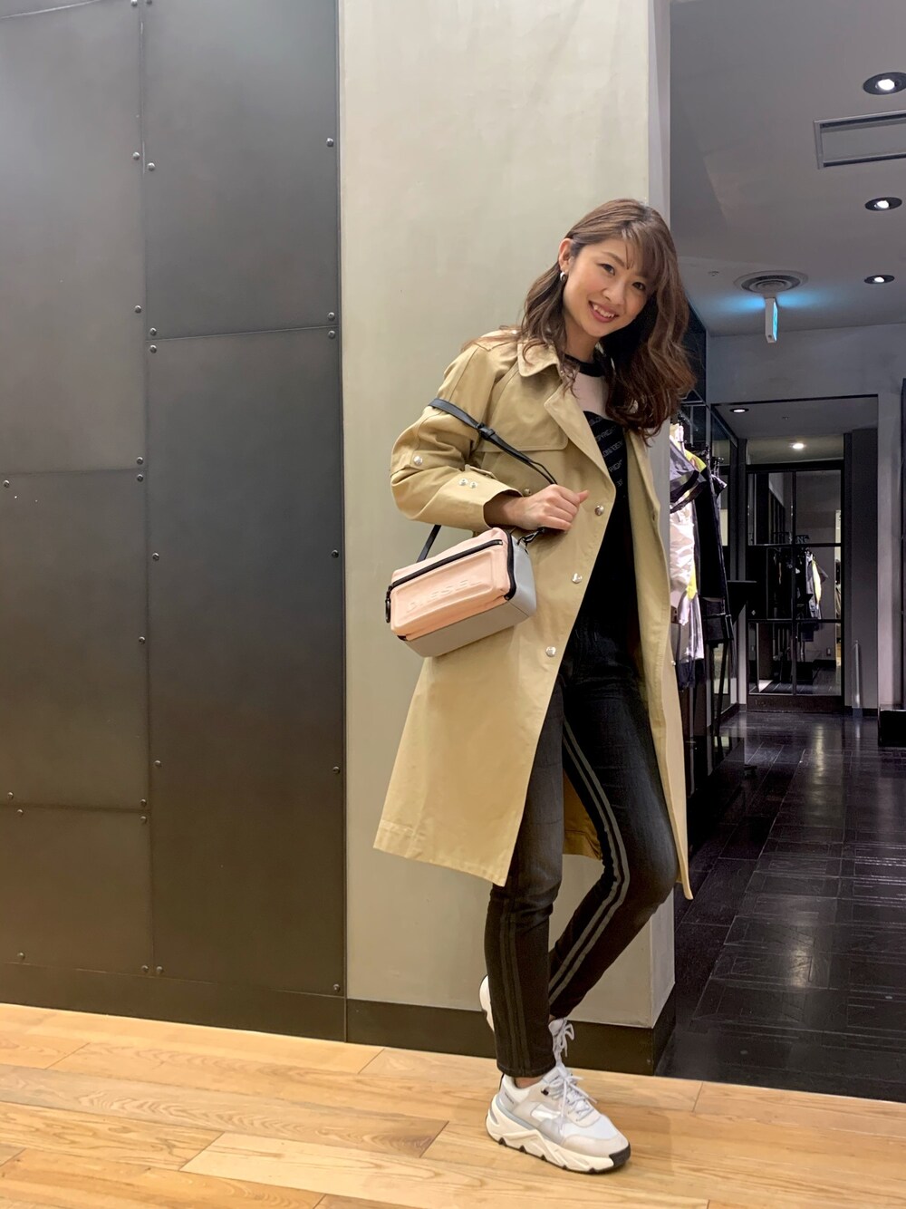 ピンク系のハンドバッグ、ブラック系のニット/セーター、ブラック系のデニムパンツを着用したレディースの春コーディネートの1枚目の写真