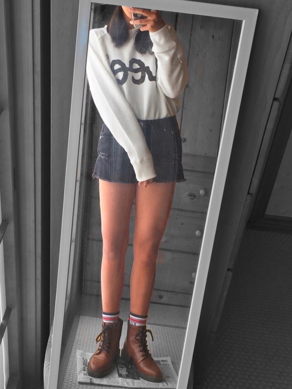 ホワイト系のスウェット、ブラウン系のブーツ、ブラック系のデニムパンツを着用したレディースの秋コーディネートの1枚目の写真