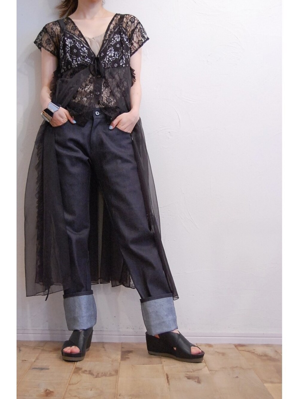 ブラック系のドレス、ブルー系のデニムパンツ、ブラック系のサンダルを着用したレディースの夏コーディネートの1枚目の写真