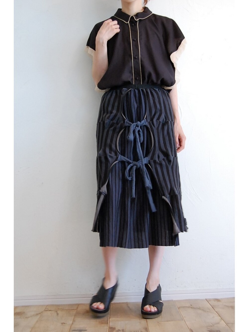 ブラック系のシャツ/ブラウス、ブラック系のスカート、ブラック系のサンダルを着用したレディースの夏コーディネートの1枚目の写真