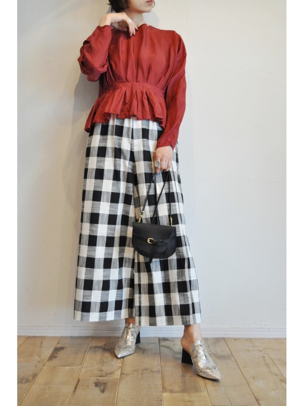 ブラック系のその他パンツ、レッド系のシャツ/ブラウス、ブラック系のショルダーバッグを着用したレディースの春コーディネートの1枚目の写真