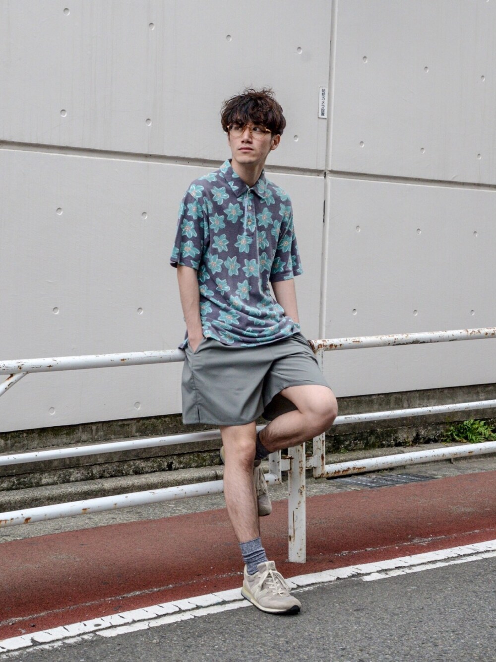 ブルー系のポロシャツ、グリーン系のパンツ、グレー系のスニーカーを着用したメンズの夏コーディネートの1枚目の写真