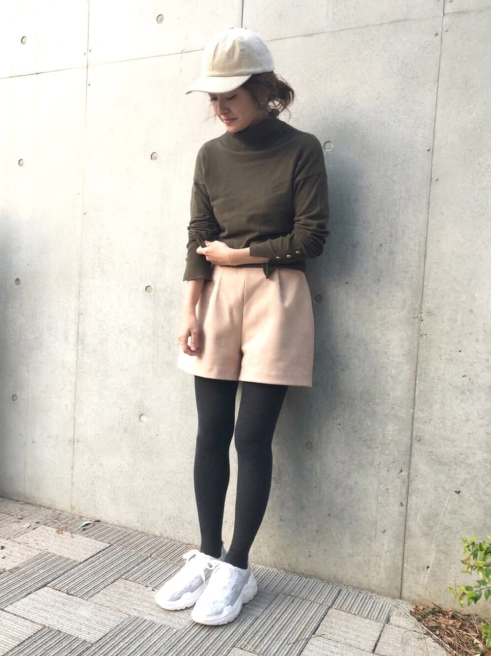 ホワイト系のスニーカー、グリーン系のニット/セーターを着用したレディースの冬コーディネートの1枚目の写真