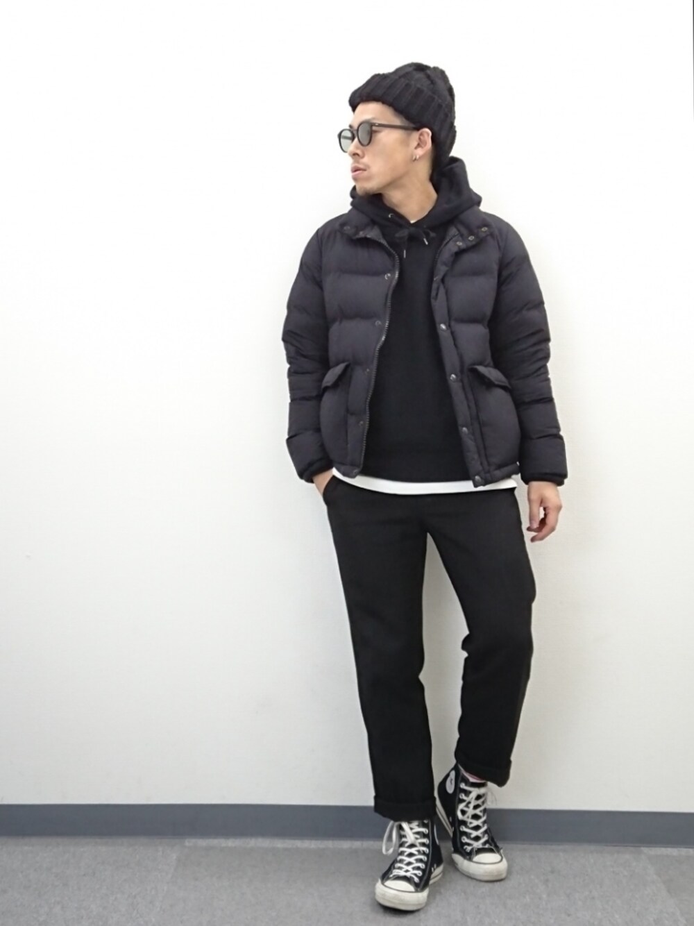 ブラック系のスニーカー、ブラック系のスラックス、ホワイト系のTシャツ/カットソーを着用したメンズの冬コーディネートの1枚目の写真