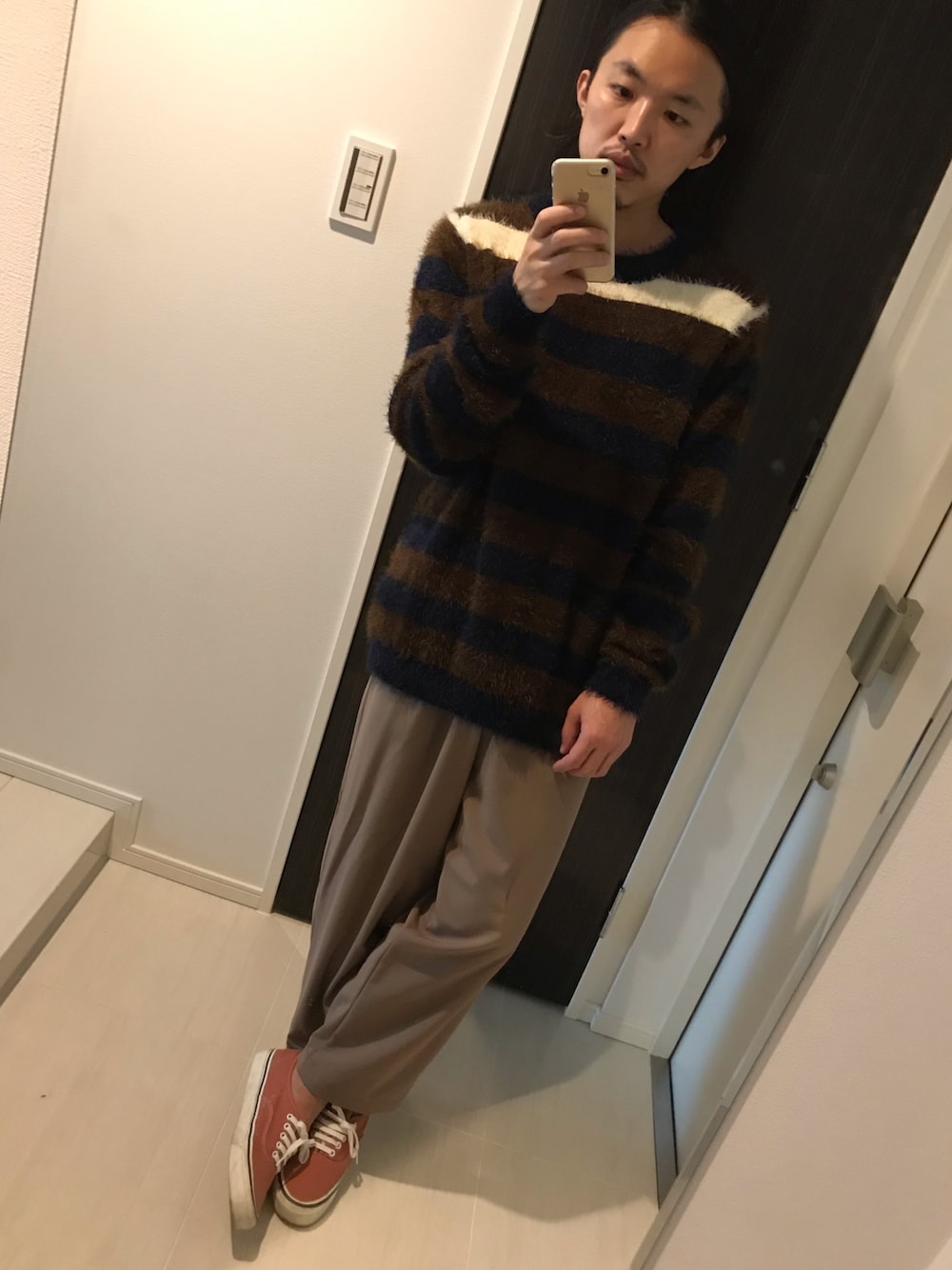 ブラウン系のニット/セーター、イエロー系のその他パンツ、レッド系のスニーカーを着用したメンズの秋コーディネートの1枚目の写真