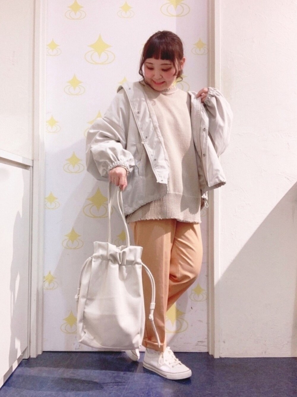 ベージュ系のブルゾン、ベージュ系のトートバッグ、ホワイト系のスニーカーを着用したレディースの春コーディネートの1枚目の写真