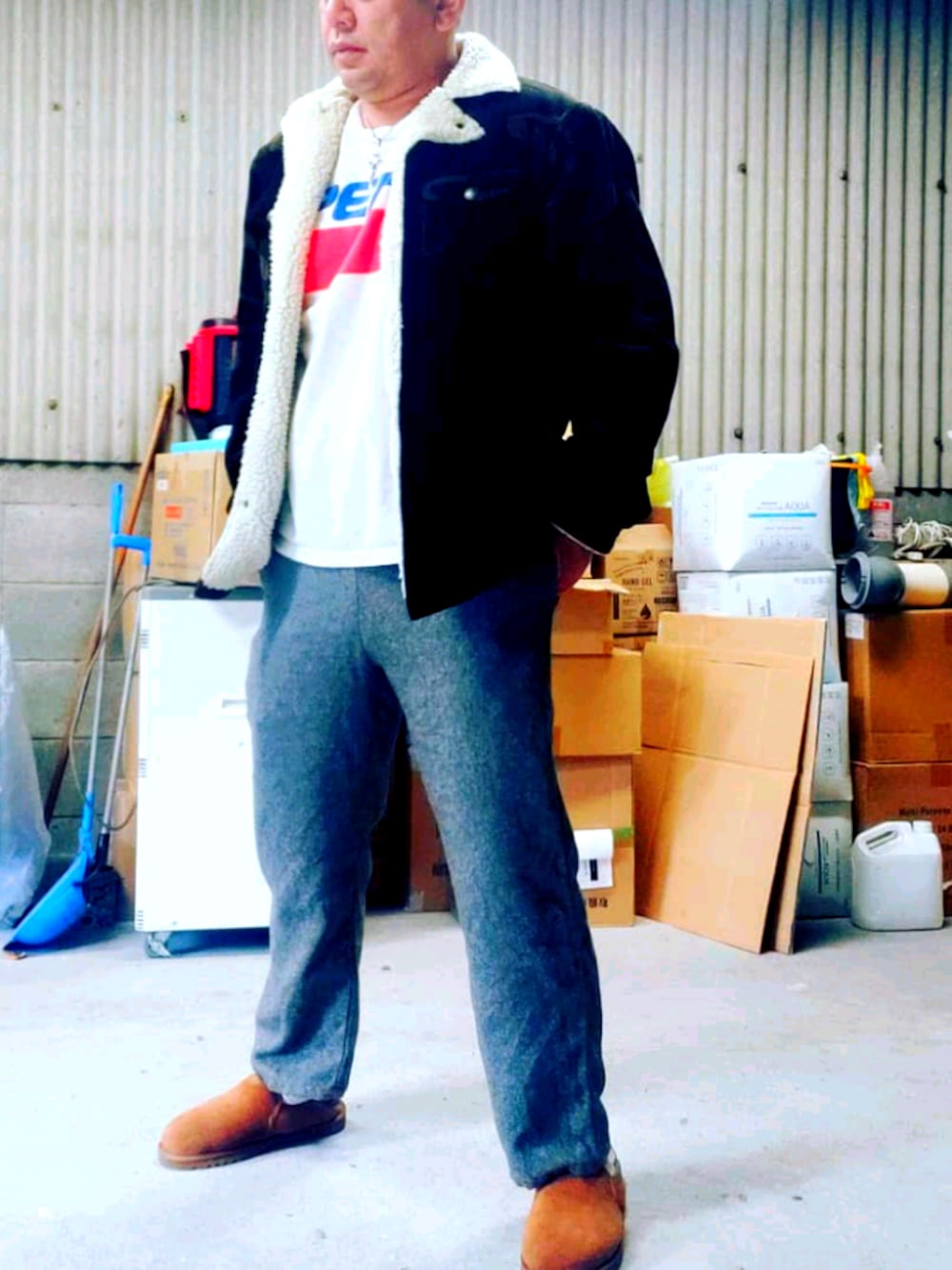 グレー系のパンツ、ブラウン系のブルゾン、ホワイト系のトップスを着用したメンズの秋コーディネートの1枚目の写真