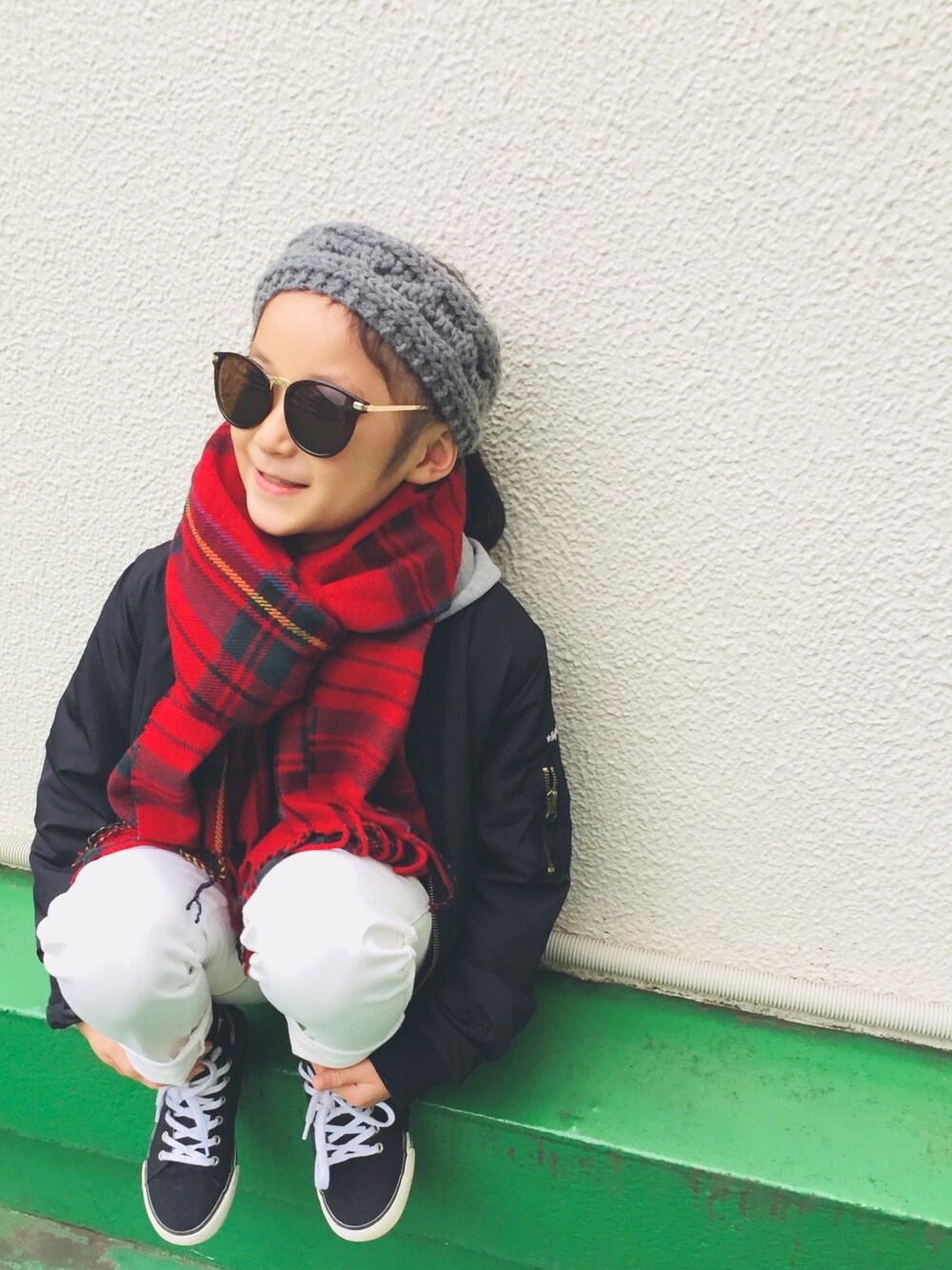 グレー系のパーカー、ホワイト系のデニムパンツ、ブラック系のスニーカーを着用したキッズの秋コーディネートの1枚目の写真