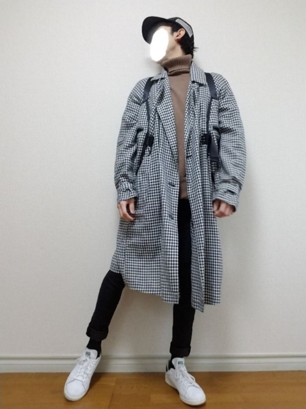 ブラウン系のニット/セーター、ブラック系のトレンチコート、ホワイト系のボディバッグ/ウエストポーチを着用したメンズの冬コーディネートの1枚目の写真