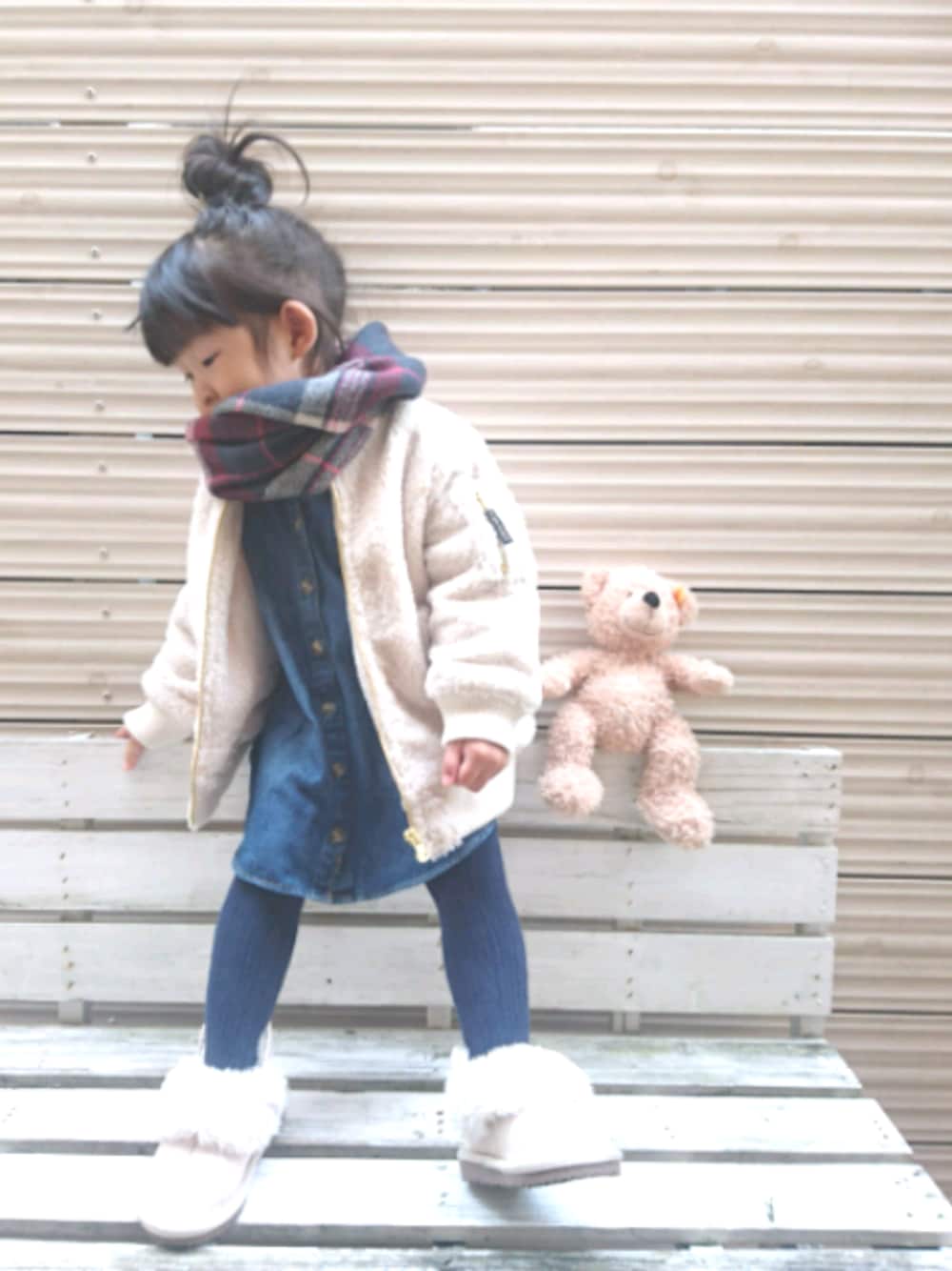 ブルー系のシャツワンピース、ホワイト系のブルゾン、ベージュ系のブーツを着用したキッズの秋コーディネートの1枚目の写真