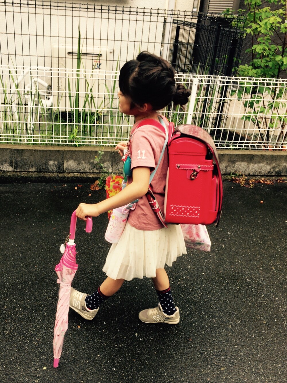 ピンク系のTシャツ/カットソー、ホワイト系のスカート、グレー系のスニーカーを着用したキッズの夏コーディネートの1枚目の写真