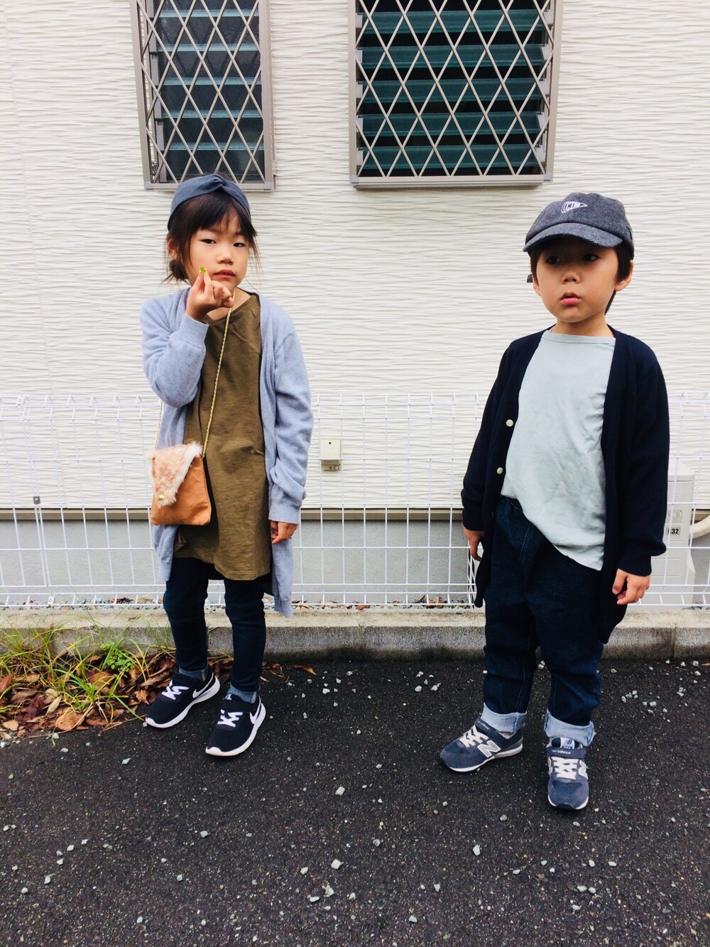 グリーン系のワンピース、ブルー系のデニムパンツ、グレー系のカーディガン/ボレロを着用したキッズの秋コーディネートの1枚目の写真