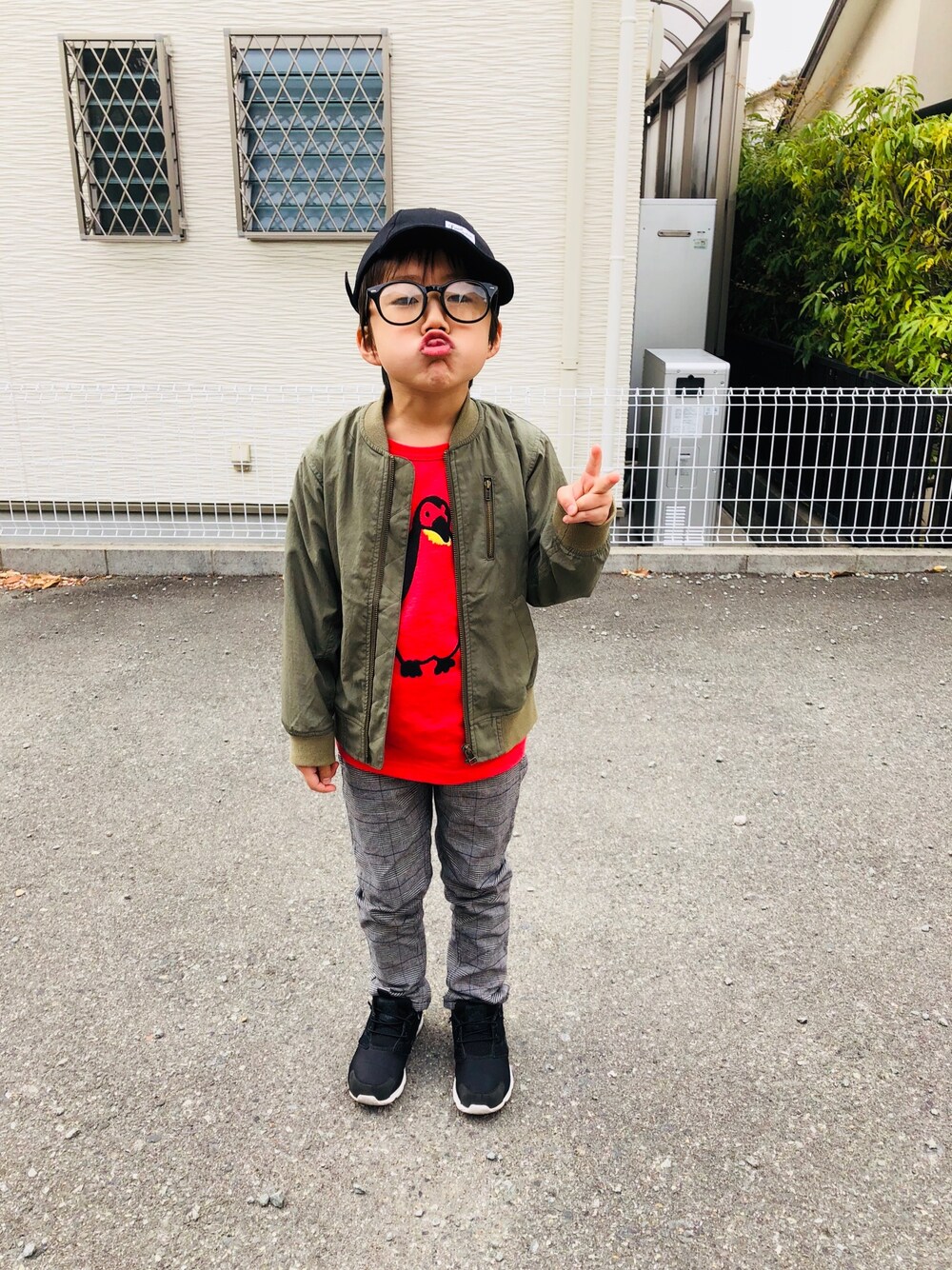 レッド系のTシャツ/カットソー、グリーン系のMA-1、グレー系のパンツを着用したキッズの春コーディネートの1枚目の写真