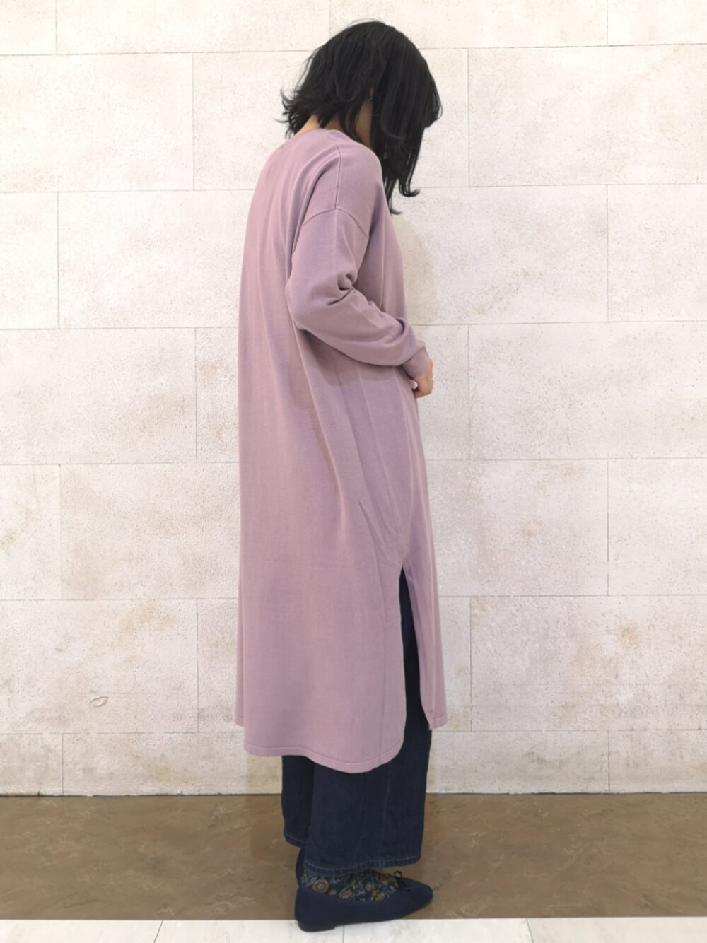 ピンク系のワンピース、レッド系のシューズ、ブルー系のデニムパンツを着用したレディースの冬コーディネートの1枚目の写真