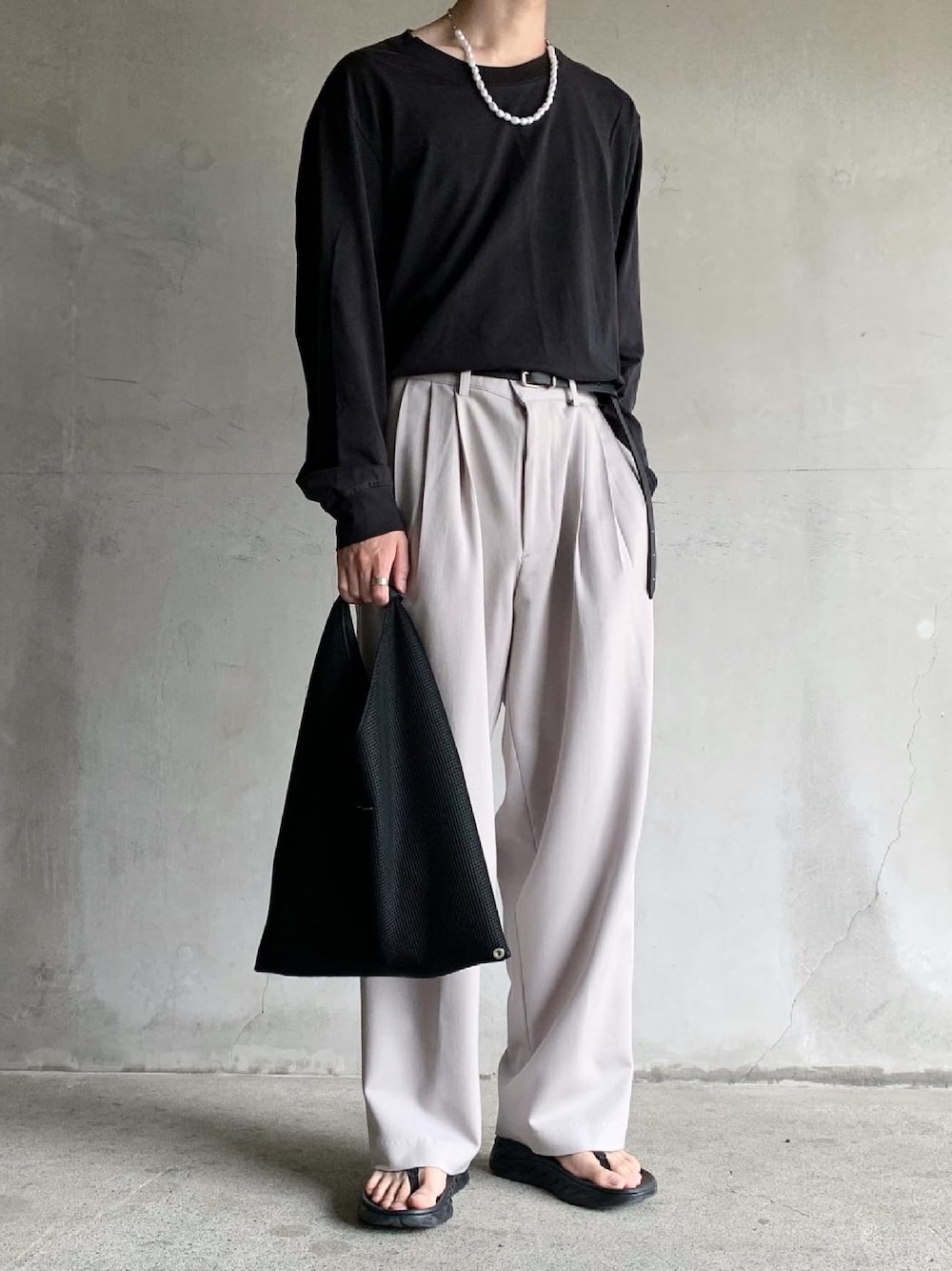 ブラック系のTシャツ/カットソー、グレー系のパンツ、ブラック系のサンダルを着用したメンズの夏コーディネートの1枚目の写真