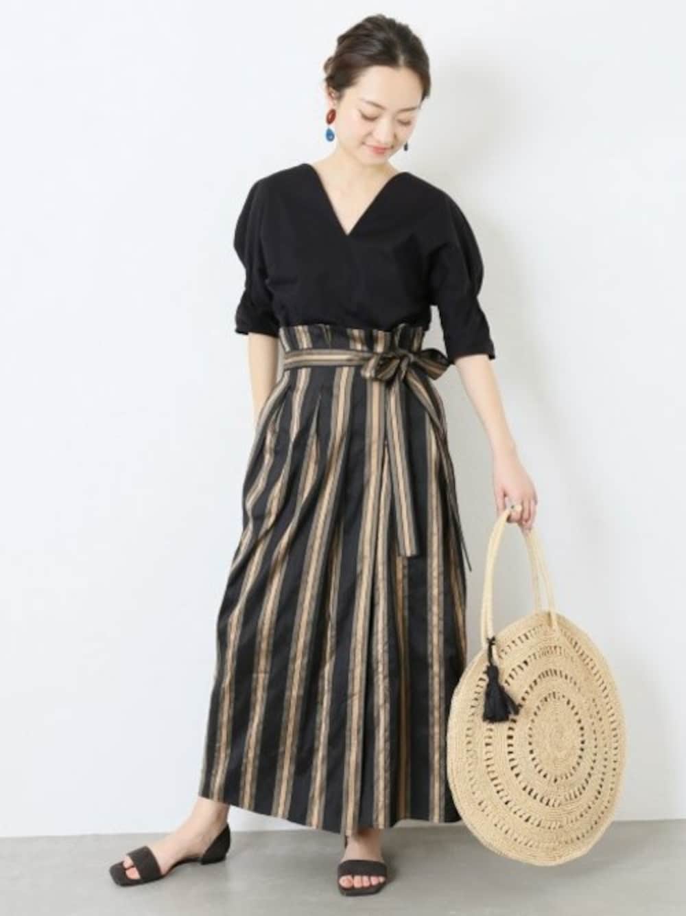 ブルー系のTシャツ/カットソー、グレー系のサンダル、ベージュ系のかごバッグを着用したレディースの春コーディネートの1枚目の写真