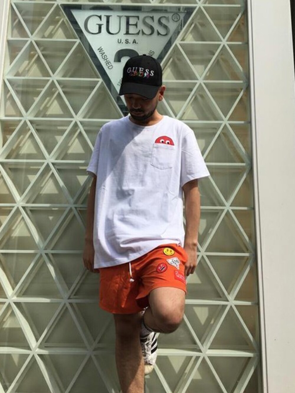 「ホワイト、キャップ、コラボ、ショートパンツ、Tシャツ、オレンジ、guess」｜「GuessのGUESS x J BALVIN EMBROIDERED LOGO SWIM SHORTS（水着、オレンジ系）」を使った、GUESS JAPANさん（メンズ・166cm）の春コーディネートの1枚目の写真