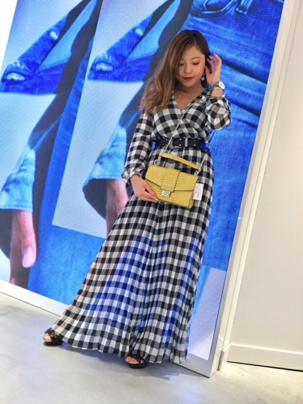 ブラック系のワンピース、イエロー系のハンドバッグを着用したレディースの夏コーディネートの1枚目の写真