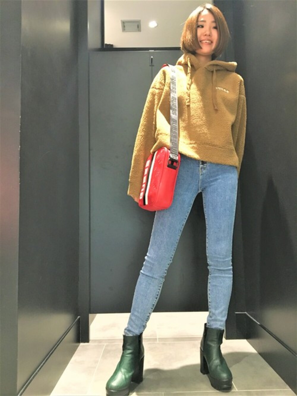 ブルー系のデニムパンツを着用したレディースの秋コーディネートの1枚目の写真