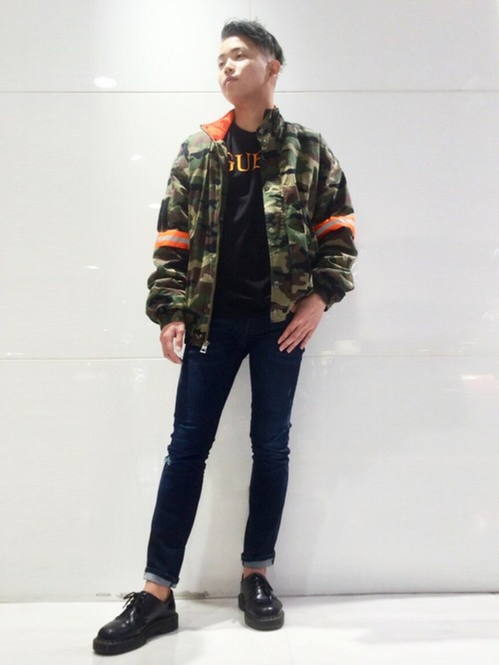 ブラック系のTシャツ/カットソー、ブルー系のデニムパンツ、グリーン系のブルゾンを着用したメンズの冬コーディネートの1枚目の写真