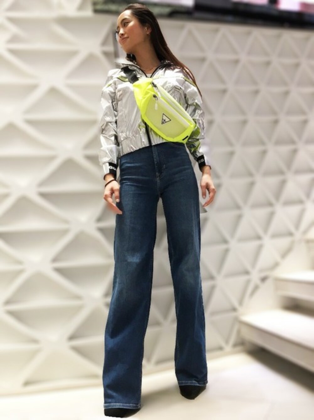 ブルー系のデニムパンツ、シルバー系のナイロンジャケット、グリーン系のボディバッグ/ウエストポーチを着用したレディースの春コーディネートの1枚目の写真