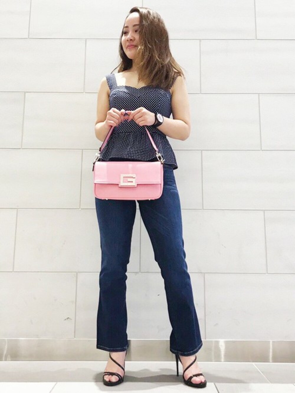 ブラック系のキャミソール、ブルー系のデニムパンツを着用したレディースの春コーディネートの1枚目の写真