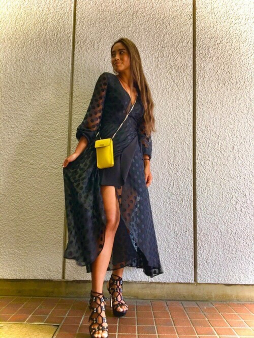 ブラック系のワンピース、イエロー系のショルダーバッグを着用したレディースの秋コーディネートの1枚目の写真