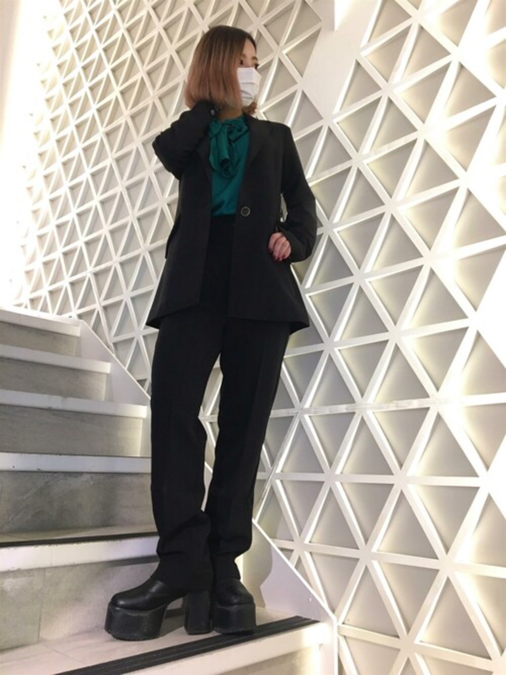 ブラック系のテーラードジャケット、ブラック系のその他パンツ、グリーン系のシャツ/ブラウスを着用したレディースの冬コーディネートの1枚目の写真