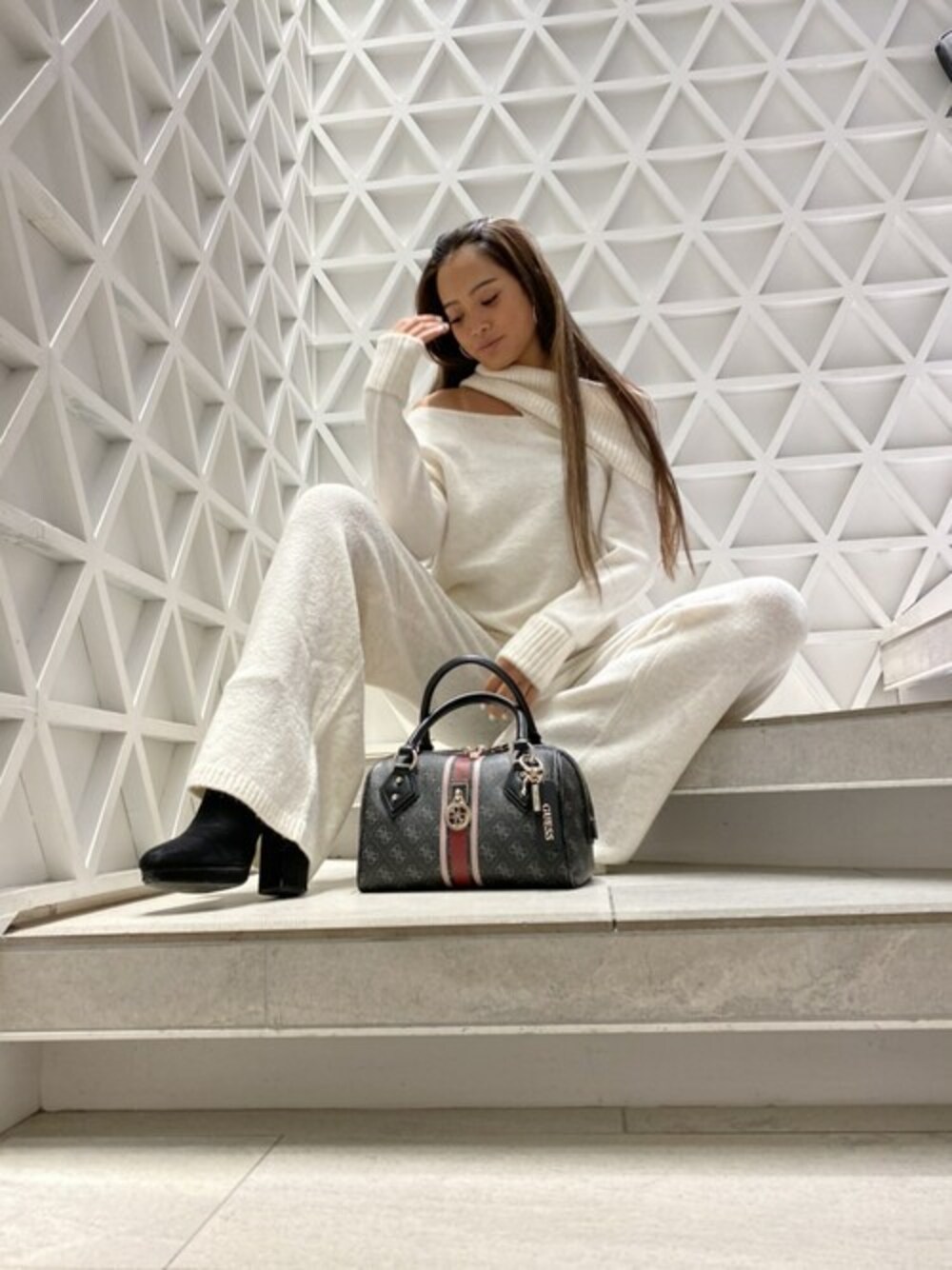 ベージュ系のニット/セーター、ベージュ系のその他パンツ、グレー系のハンドバッグを着用したレディースの冬コーディネートの1枚目の写真