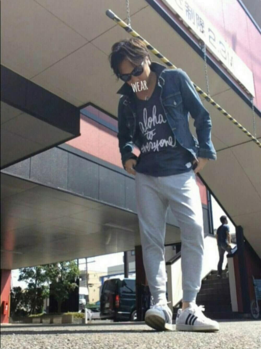 ブルー系のデニムジャケット、ブルー系のTシャツ/カットソー、ホワイト系のスニーカーを着用したメンズの春コーディネートの1枚目の写真