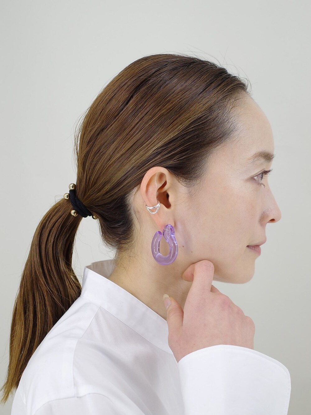 パープル系のピアス（両耳用）、シルバー系のイヤーカフを着用したレディースの冬コーディネートの1枚目の写真