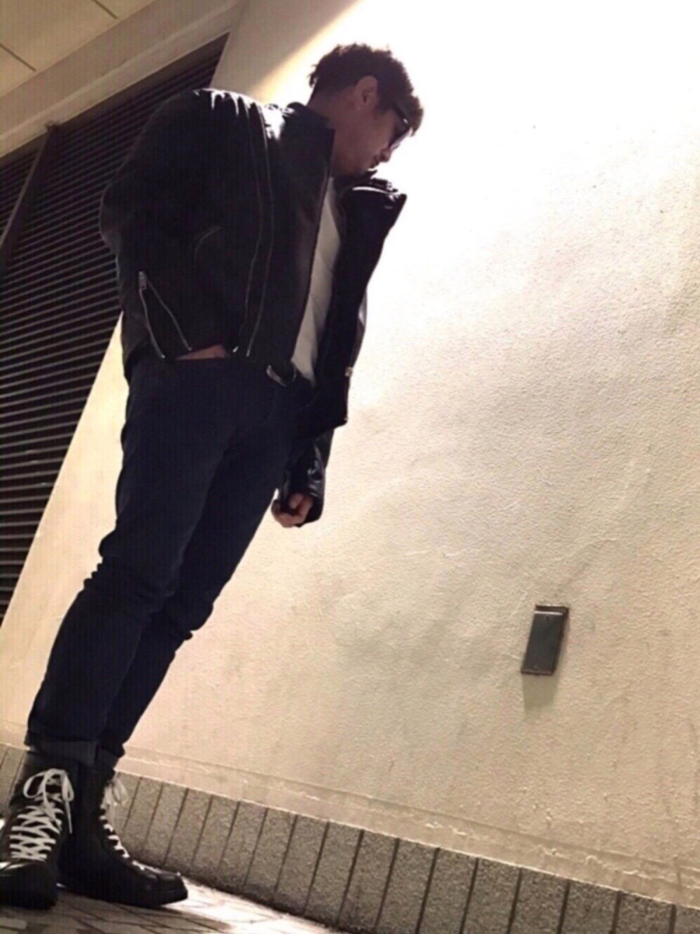 ブラック系のライダースジャケット、ホワイト系のTシャツ/カットソー、ブラック系のブーツを着用したメンズの冬コーディネートの1枚目の写真