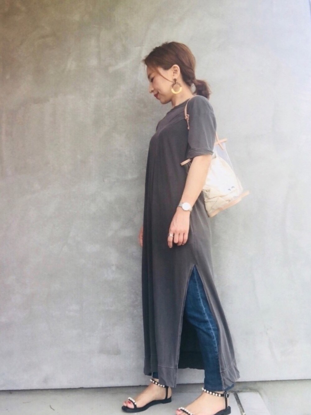 シルバー系のショルダーバッグ、ブラック系のサンダル、グレー系のワンピースを着用したレディースの夏コーディネートの1枚目の写真