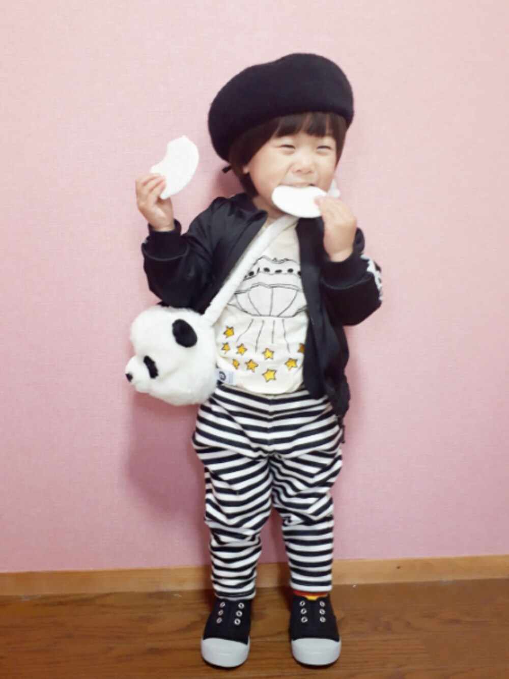 ブラック系のパンツ、ブラック系のブルゾン、ホワイト系のショルダーバッグを着用したキッズの冬コーディネートの1枚目の写真