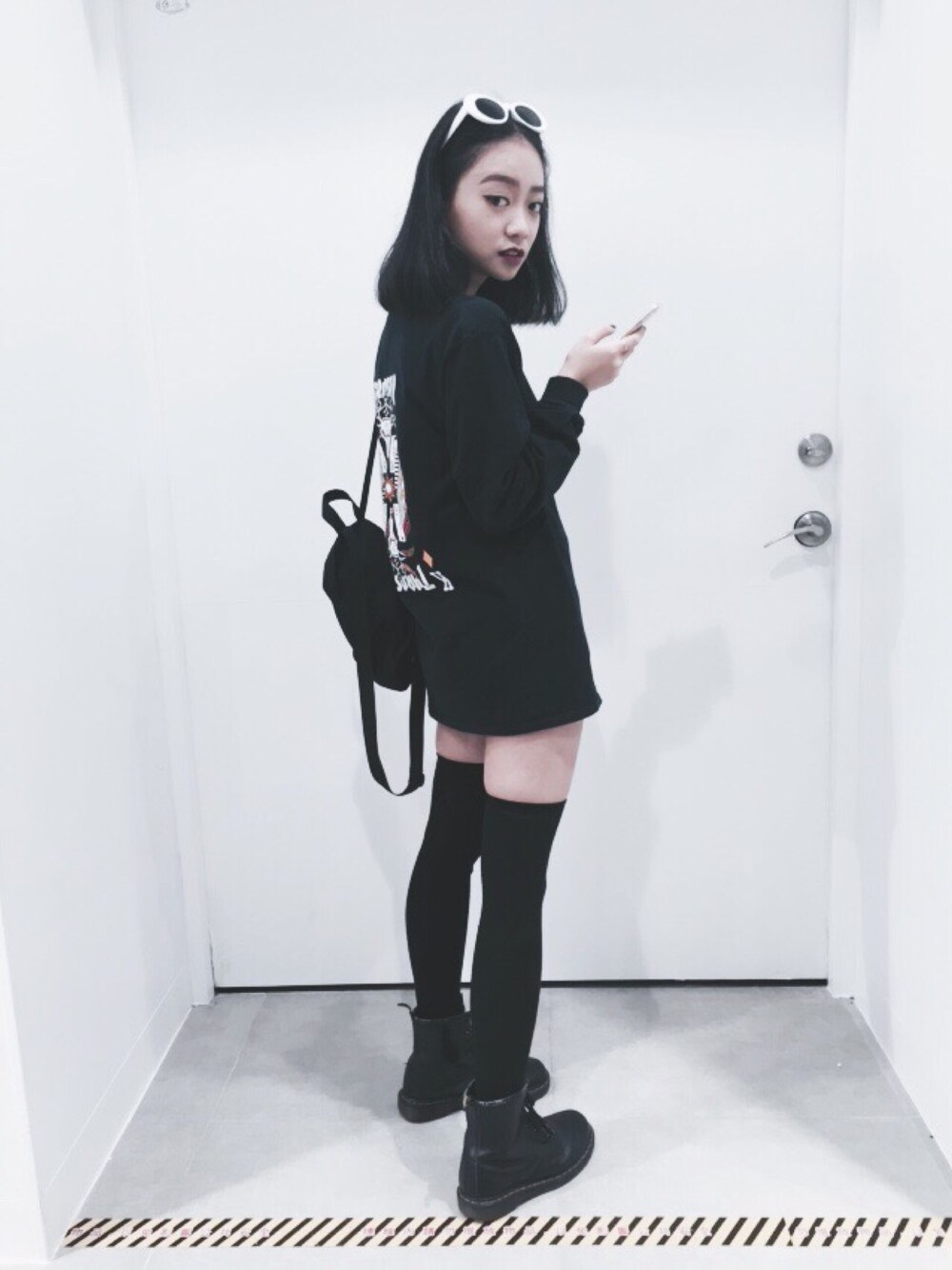 「ALL BLACK、ootd、streetstyle、Dr.Martens、THRASHER、Dickies、stockings、Sunglasses、autumn、outfit」｜「DickiesのDickies X UO Mini Backpack（バックパック/リュック、ブラック系）」を使った、Serena Chenさん（レディース・164cm）の冬コーディネートの1枚目の写真