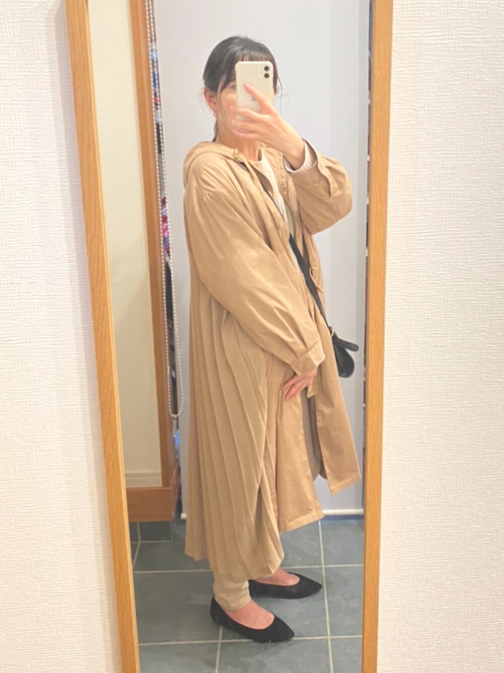 ベージュ系のジャケット/アウター、ブラック系のショルダーバッグ、ホワイト系のニット/セーターを着用したレディースの春コーディネートの1枚目の写真