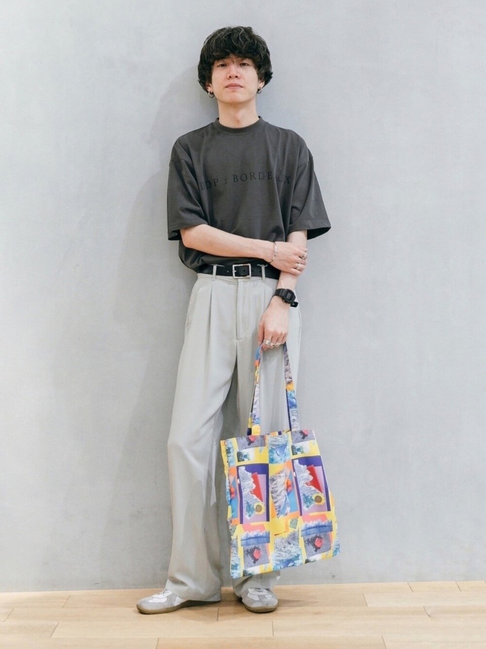 グレー系のTシャツ/カットソー、その他のトートバッグ、ホワイト系のスニーカーを着用したメンズの春コーディネートの1枚目の写真