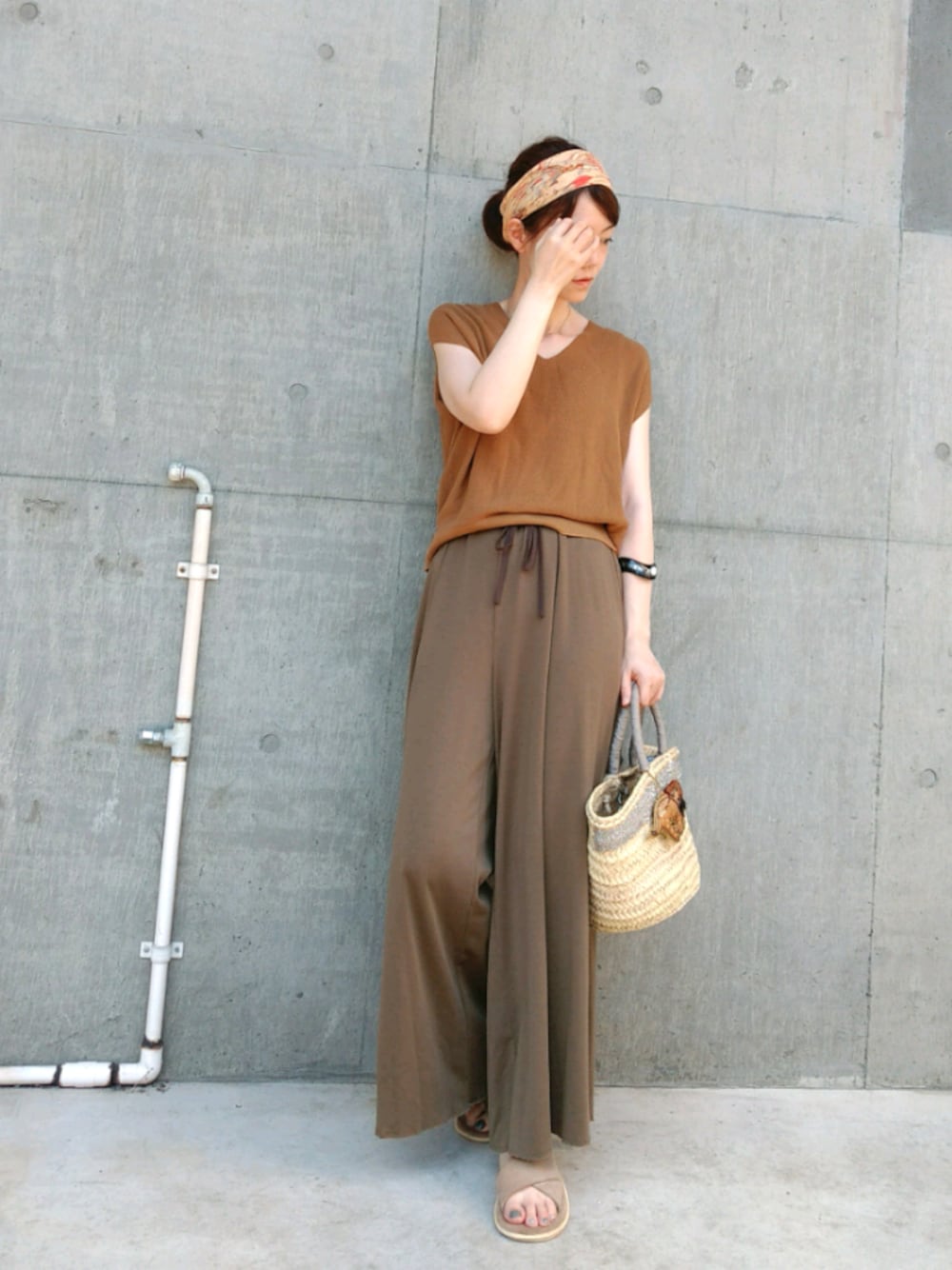 イエロー系のニット/セーター、ベージュ系のサンダル、グリーン系のその他パンツを着用したレディースの夏コーディネートの1枚目の写真