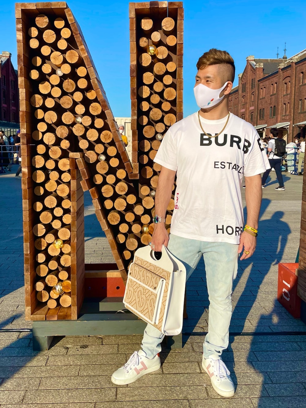 ホワイト系のTシャツ/カットソー、ブルー系のデニムパンツ、その他のバッグを着用したメンズの春コーディネートの1枚目の写真